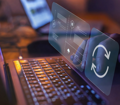 Hand interacting with a digital interface showing a refresh icon above a laptop, representing Open iT LicenseAnalyzer for advanced license analyzer insights.